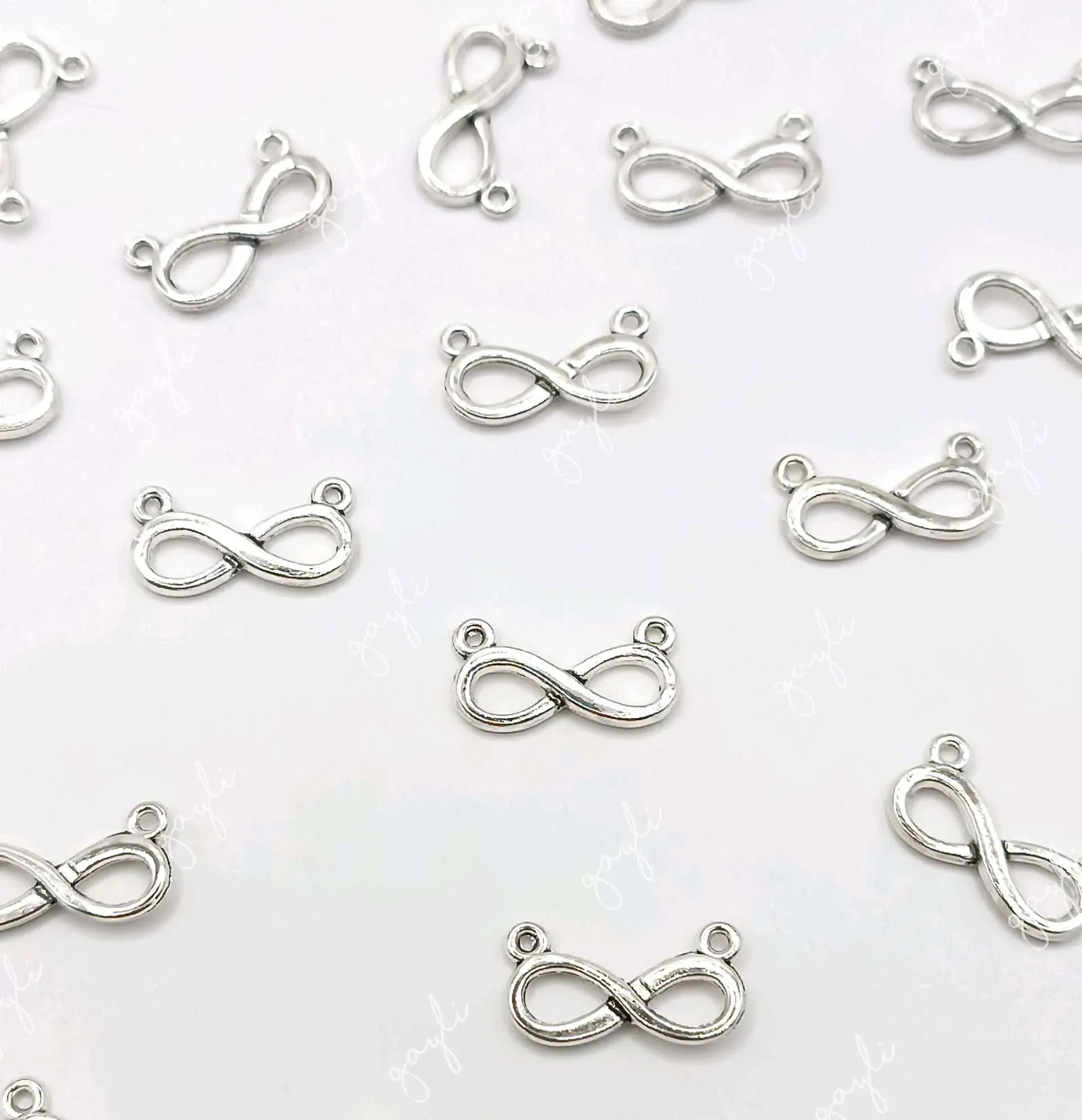 Dije infinito metálico con doble aro / 50 unidades